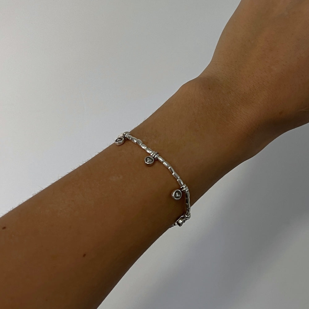 Indulge in love with our Endless Love Charm Silver Beaded Bracelet! Crafted with hill tribe silver beads on a wax string, this bracelet is adorned with six delicate heart charms, reminding you of love's infinite power. Perfect for any occasion, this bracelet will inspire you to spread love wherever you go!