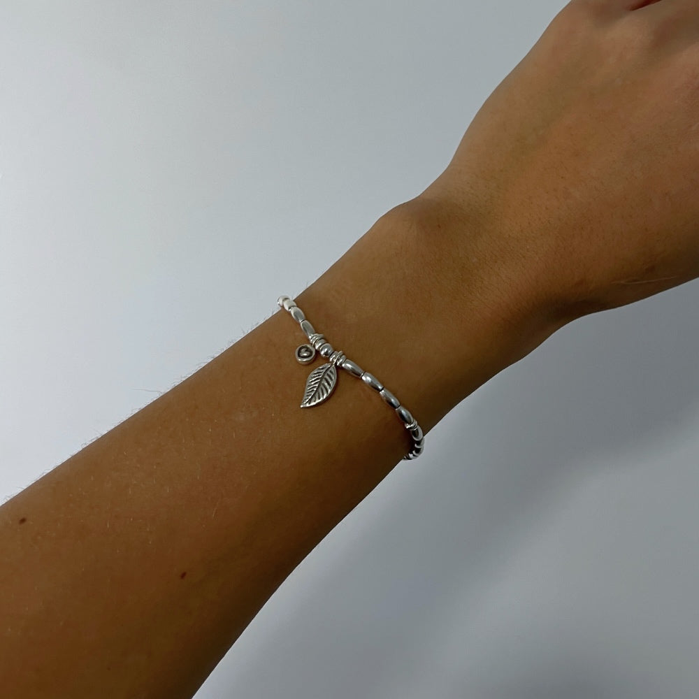 Get inspired by our Leafy Love Charm Silver Beaded Bracelet! Hand-crafted with sterling silver beads and wax string, this bracelet flaunts a sweet little heart charm and a centre-leaf charm. Show your love for fashion and nature with this one-of-a-kind accessory.