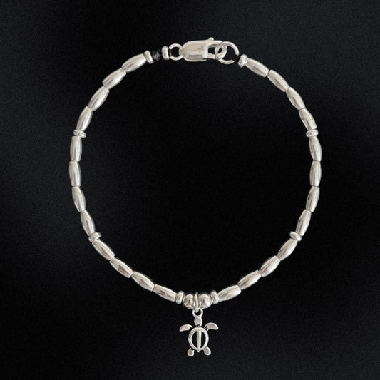 This stunning Turtle Charm Sterling Silver Beaded Bracelet is a must-have for any jewellery lover. Made of high-quality sterling silver beads, this bracelet is carefully crafted on a wax string, with a beautiful turtle charm at its centre. Its elegant design combined with its durability will add a touch of sophistication to any outfit.