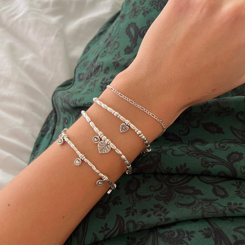 Indulge in the perfect expression of love with our Silver Sweetheart Charm Beaded Bracelet. Made with sterling silver beads, this bracelet is delicately strung on wax string, featuring a charming heart at its centre. Add a touch of elegance to any outfit and let your love shine through!