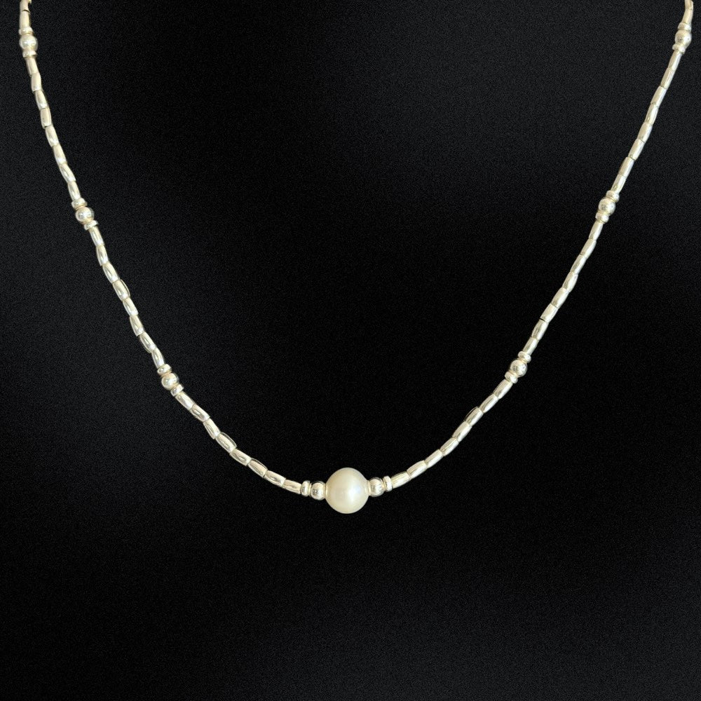 Introducing our Hill Tribe Silver & Pearl Necklace, a fusion of tradition and elegance. Meticulously handcrafted in Australia, this beaded necklace features a central freshwater pearl embraced by intricate silver beads. The pearl, symbolising purity and timeless beauty, adds sophistication. Finished with a lobster clasp, this piece is versatile for any occasion, blending cultural heritage with refined style. Elevate your look with this timeless treasure.