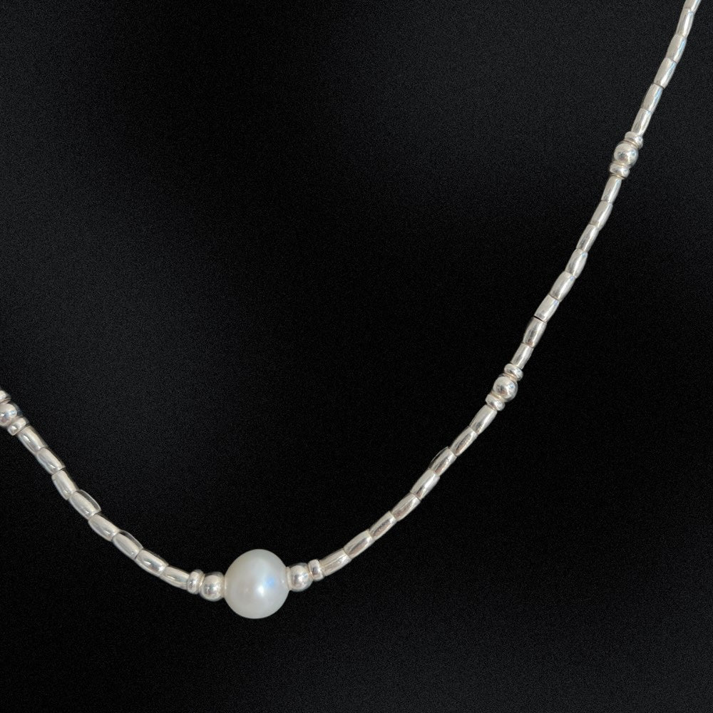 Introducing our Hill Tribe Silver & Pearl Necklace, a fusion of tradition and elegance. Meticulously handcrafted in Australia, this beaded necklace features a central freshwater pearl embraced by intricate silver beads. The pearl, symbolising purity and timeless beauty, adds sophistication. Finished with a lobster clasp, this piece is versatile for any occasion, blending cultural heritage with refined style. Elevate your look with this timeless treasure.