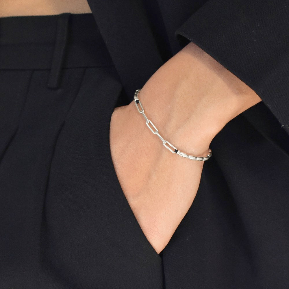 The ultimate fashion statement that effortlessly elevates any outfit! Handcrafted to perfection, this bracelet boasts of delicate sterling silver beads that beautifully sit around your wrist, giving you an exquisite and timeless look.